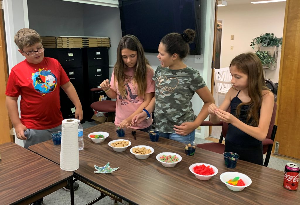 children using bowls of snacks to make jello bowls