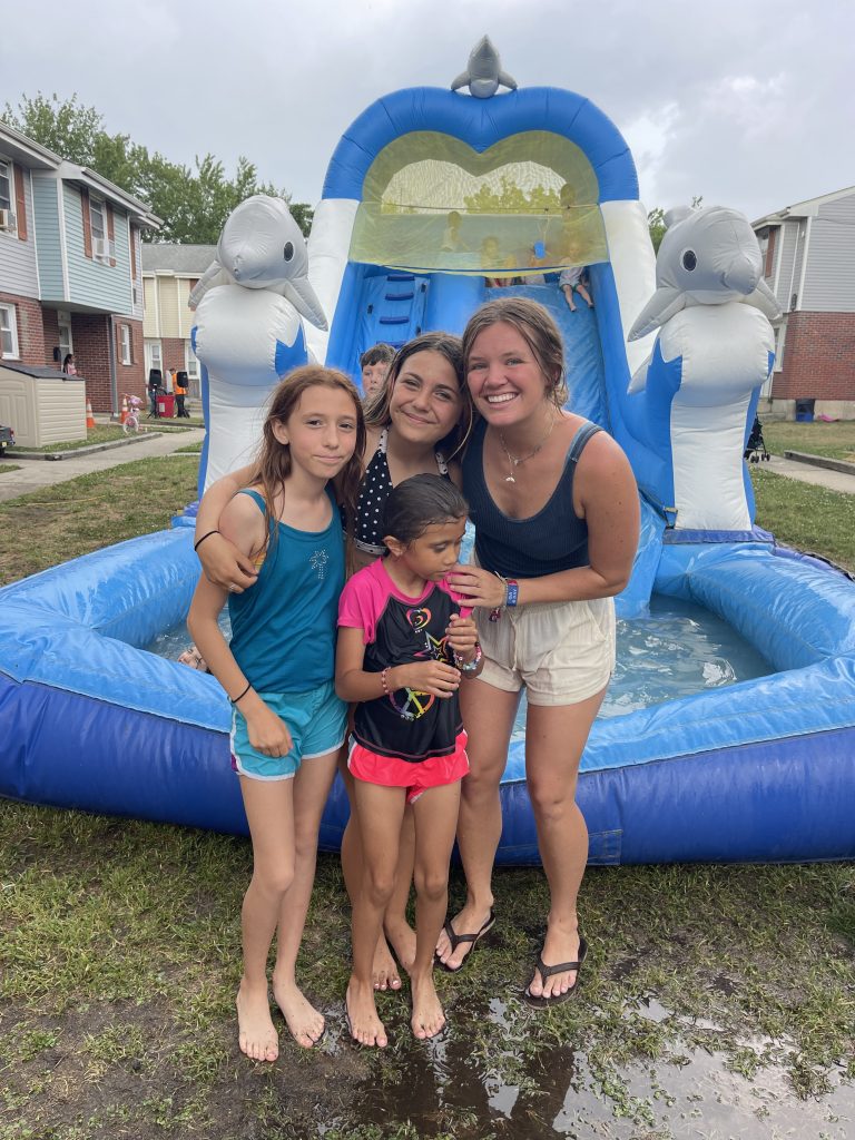 four girls standing together in front of a water slide in cape may